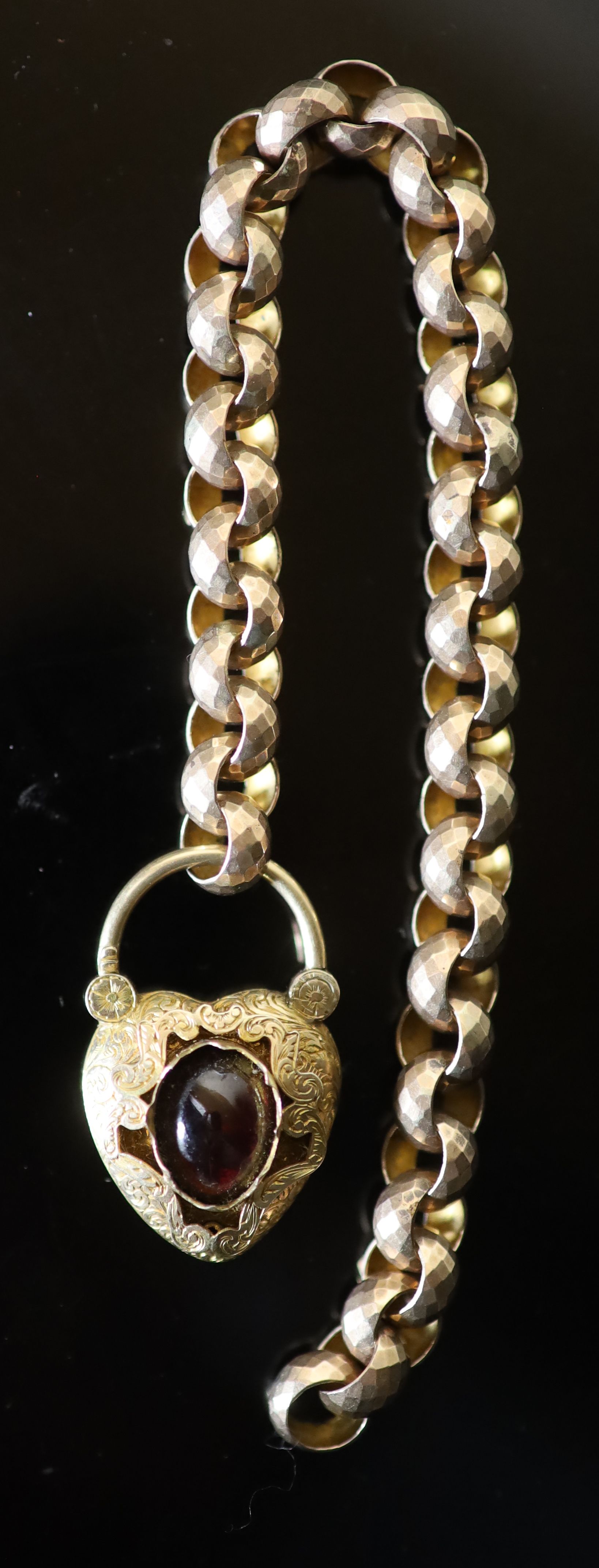 A Victorian facetted gold link bracelet, with associated? engraved gold and cabochon garnet set heart shaped padlock clasp,